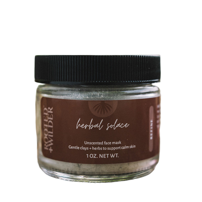 Jar of herbal face mask with a black lid on a white background
